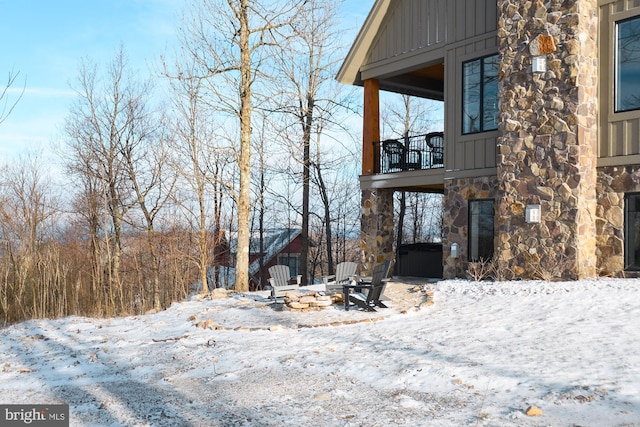 view of snowy exterior featuring a balcony