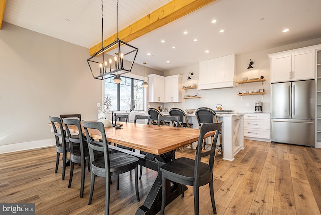 dining area with a chandelier, vaulted ceiling with beams, light wood-type flooring, and wooden ceiling