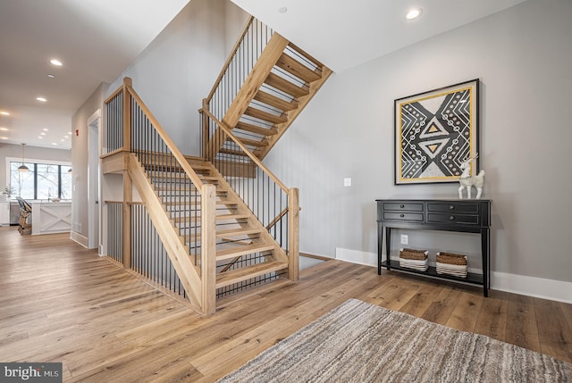 staircase featuring hardwood / wood-style flooring