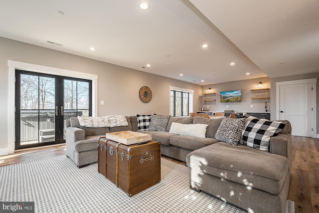 living room featuring plenty of natural light and light hardwood / wood-style flooring