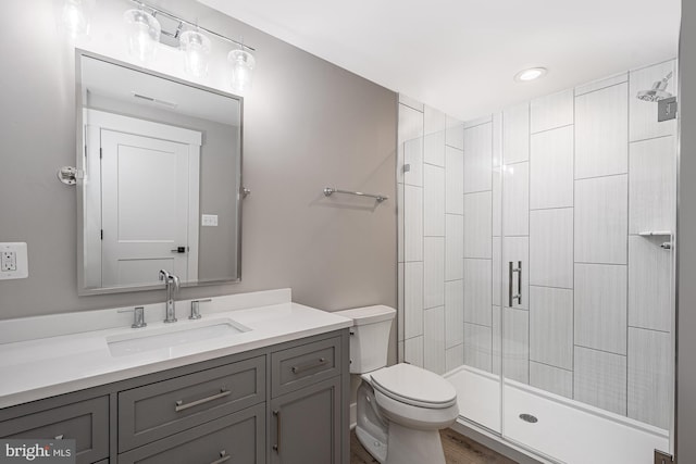 bathroom featuring hardwood / wood-style floors, toilet, an enclosed shower, and vanity