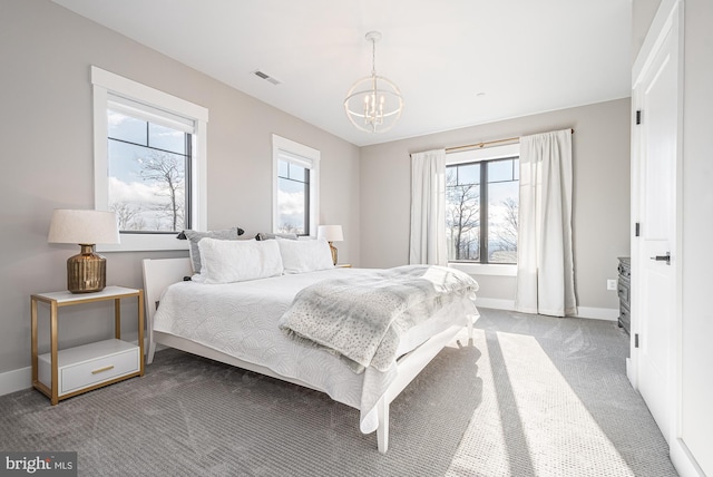 bedroom with carpet flooring and an inviting chandelier