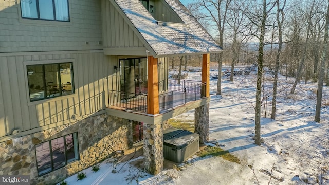 view of snow covered exterior featuring a balcony