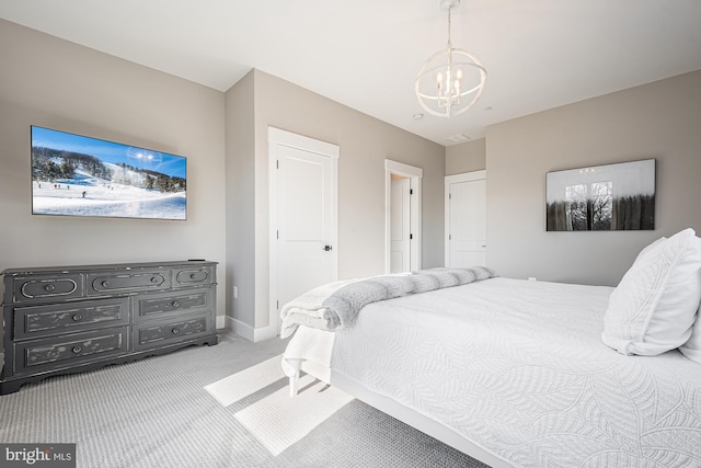 carpeted bedroom featuring a chandelier