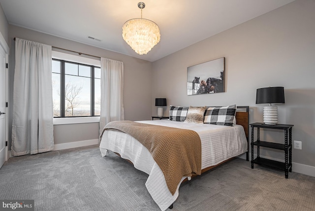 carpeted bedroom featuring a chandelier