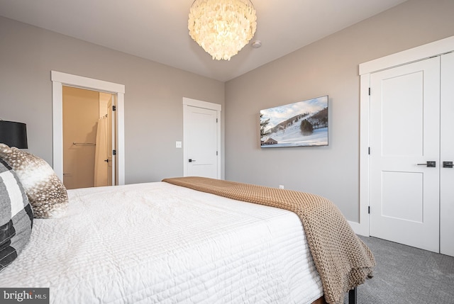 carpeted bedroom featuring a notable chandelier