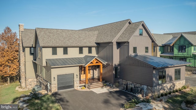 view of front of home featuring central AC and a garage