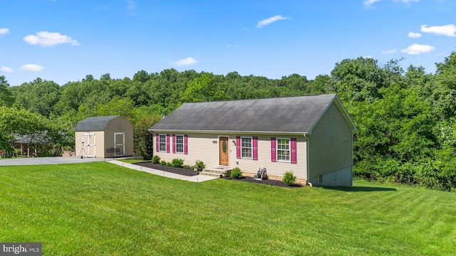 view of front of house featuring a front yard and a shed