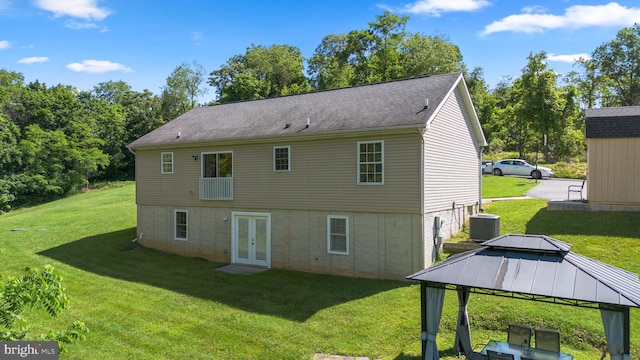 rear view of house featuring a gazebo, central AC, a yard, and french doors