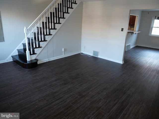 unfurnished living room featuring dark hardwood / wood-style flooring