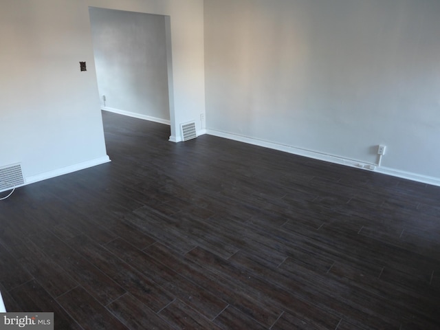 empty room featuring dark wood-type flooring