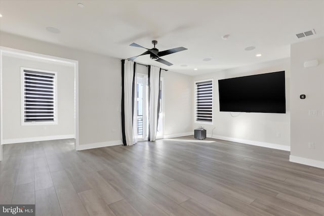 unfurnished living room with light hardwood / wood-style flooring and ceiling fan