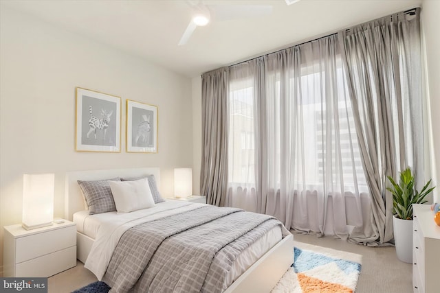 bedroom featuring ceiling fan and light colored carpet