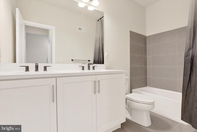 full bathroom featuring tile patterned floors, vanity, toilet, and shower / tub combo with curtain