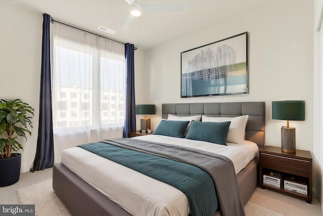 bedroom with ceiling fan and light colored carpet