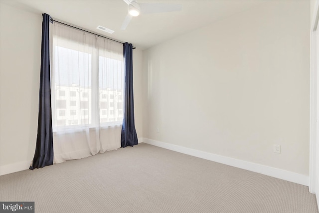 carpeted empty room featuring ceiling fan