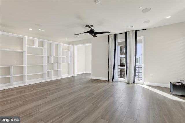 empty room with light hardwood / wood-style flooring and ceiling fan