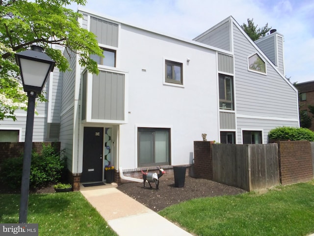 1710 Oakwood Ter Unit 3E, Penn Valley, PA 19072 - view of front of house featuring a chimney and board and batten siding