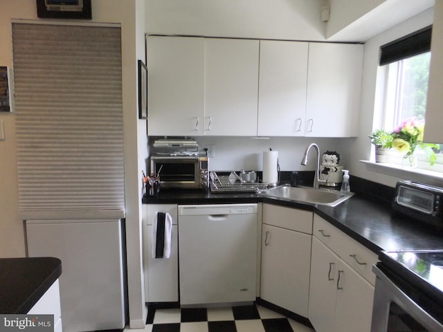 kitchen with dishwasher, white cabinets, and sink