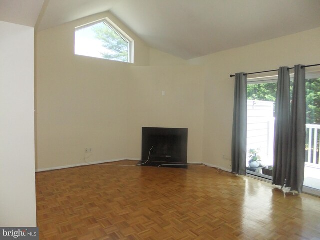 1710 Oakwood Ter Unit 3E, Penn Valley, PA 19072 - unfurnished living room featuring a fireplace with flush hearth, high vaulted ceiling, and baseboards