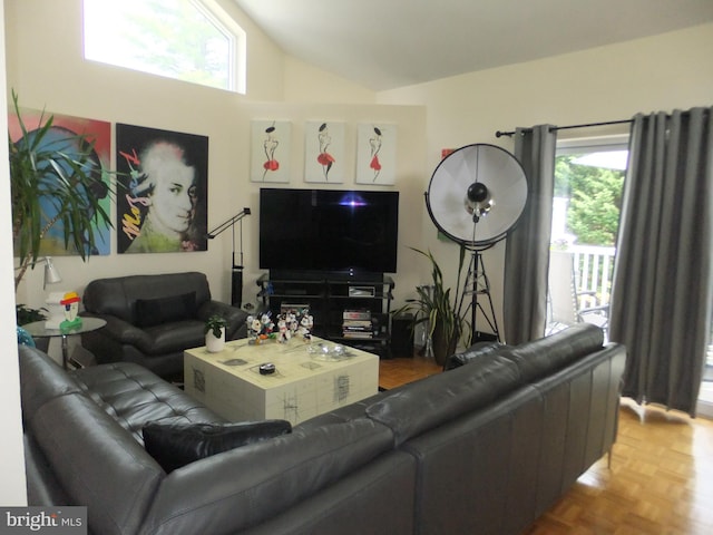 living room featuring high vaulted ceiling and parquet flooring