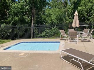 1710 Oakwood Ter Unit 3E, Penn Valley, PA 19072 - view of pool with a patio and view of wooded area