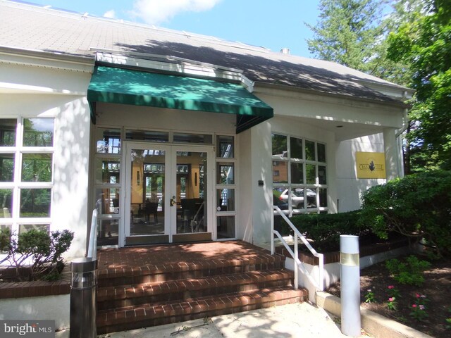 1710 Oakwood Ter Unit 3E, Penn Valley, PA 19072 - doorway to property with french doors and stucco siding