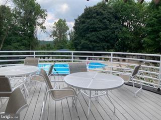 1710 Oakwood Ter Unit 3E, Penn Valley, PA 19072 - wooden deck featuring outdoor dining area