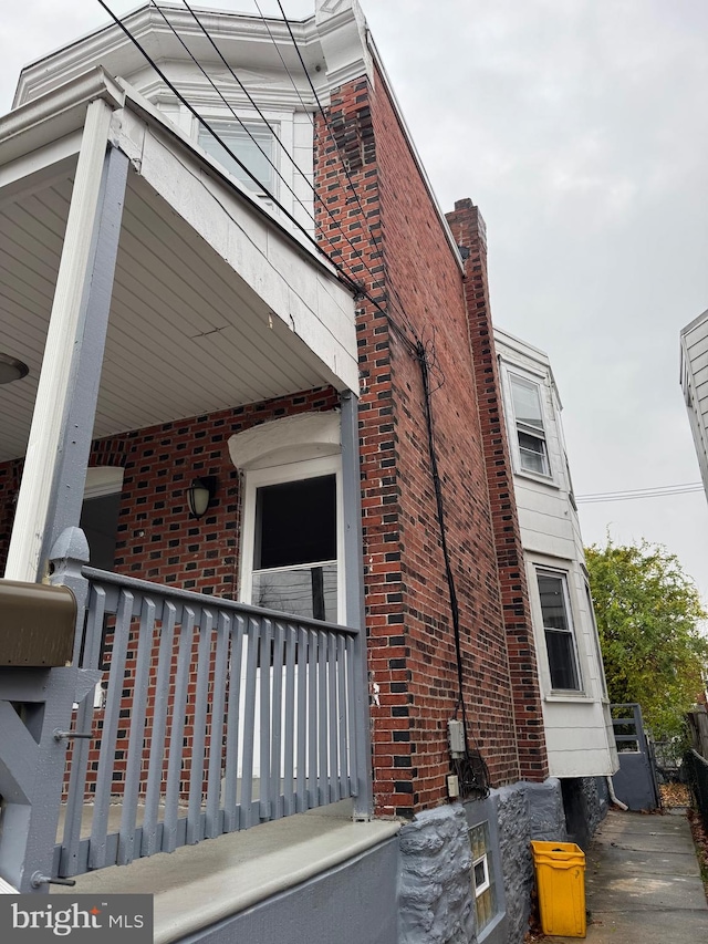 view of side of home featuring a porch