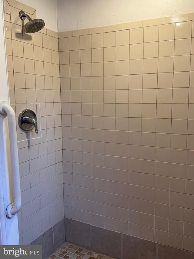 bathroom with a tile shower