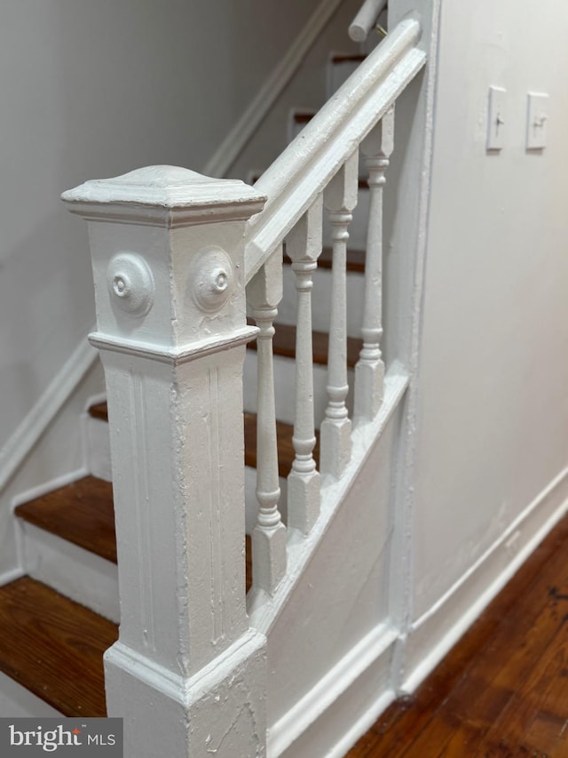 staircase featuring hardwood / wood-style flooring