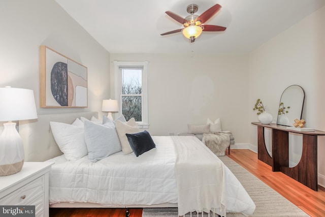 bedroom featuring hardwood / wood-style floors and ceiling fan