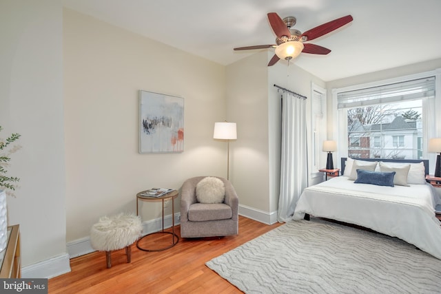 bedroom with wood-type flooring and ceiling fan