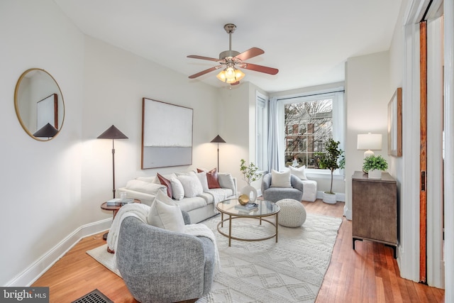 living room featuring ceiling fan and hardwood / wood-style floors