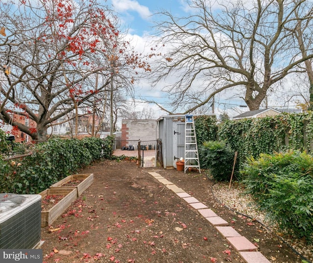 view of yard with central AC and a storage shed