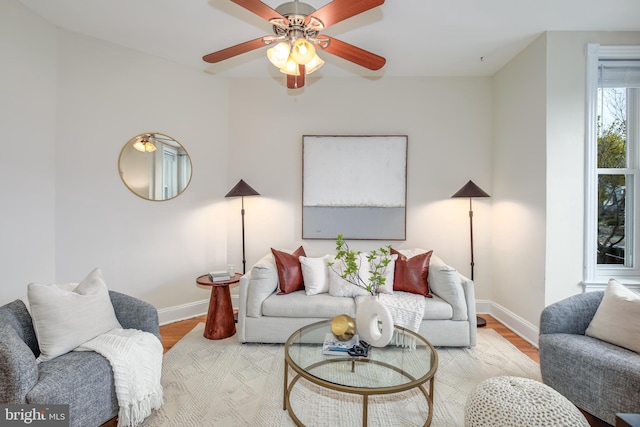 living room featuring ceiling fan and light wood-type flooring