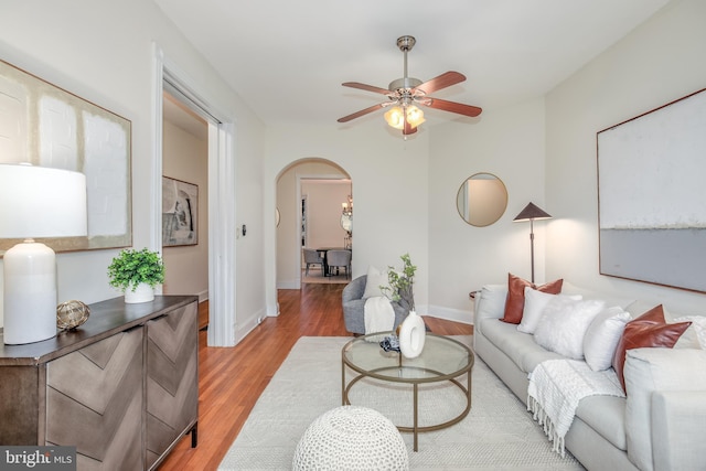 living room with ceiling fan and wood-type flooring