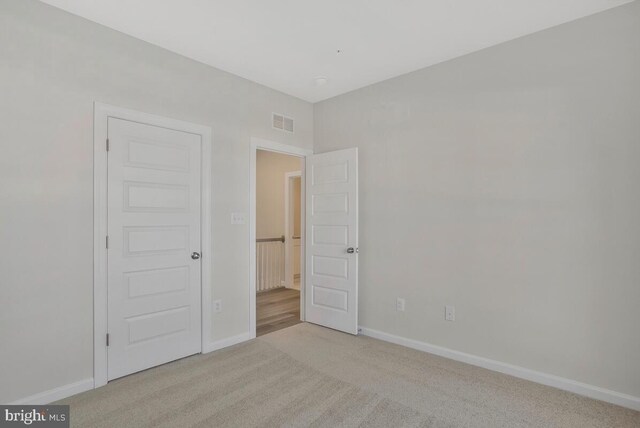 interior space featuring light carpet