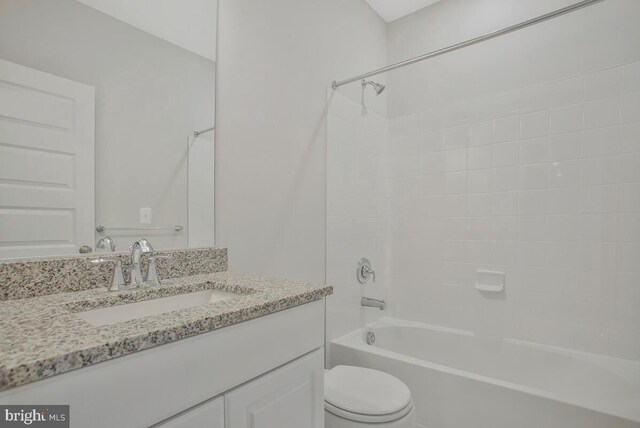 full bathroom with vanity, toilet, and tiled shower / bath combo