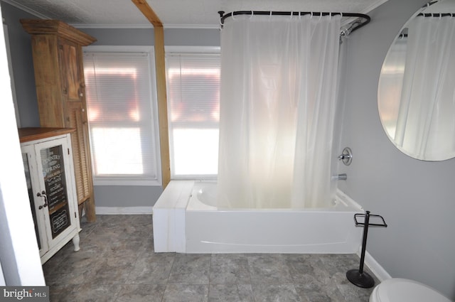 bathroom with toilet, shower / tub combo, and ornamental molding