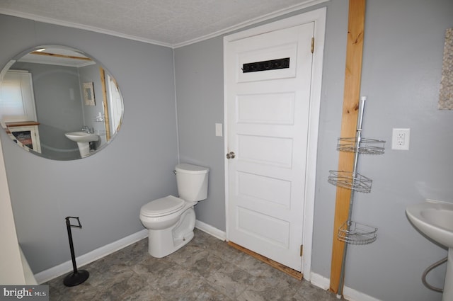 bathroom featuring crown molding, a textured ceiling, and toilet