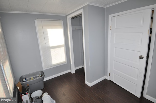 unfurnished bedroom featuring dark hardwood / wood-style flooring and crown molding