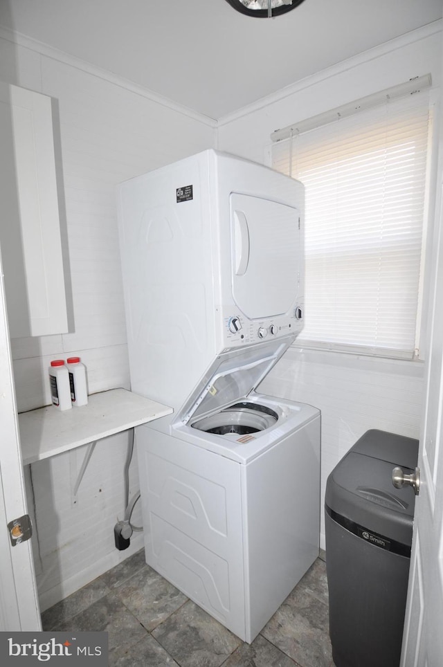 washroom featuring stacked washer and dryer