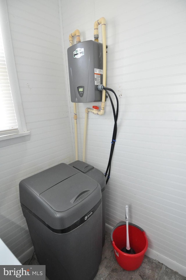 utility room featuring water heater