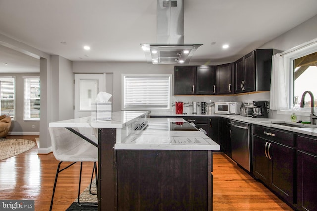 kitchen with a kitchen bar, island exhaust hood, light wood-type flooring, dishwasher, and a center island