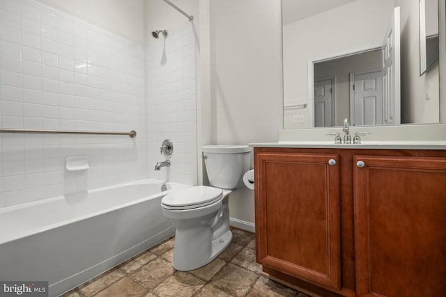 full bathroom featuring vanity, tiled shower / bath combo, and toilet