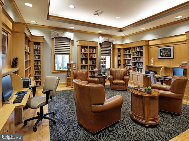 home office featuring hardwood / wood-style flooring and a tray ceiling