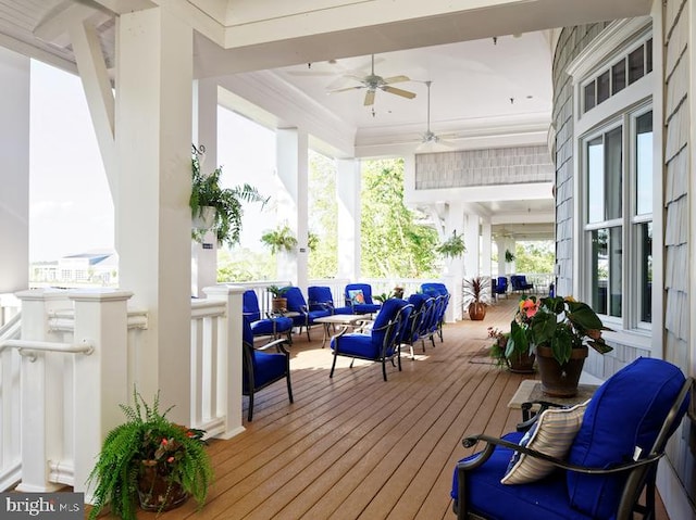 deck with ceiling fan, a porch, and an outdoor living space