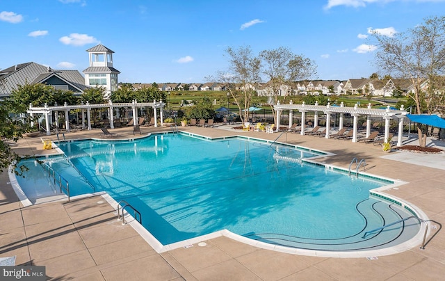 view of swimming pool featuring a patio area and a pergola