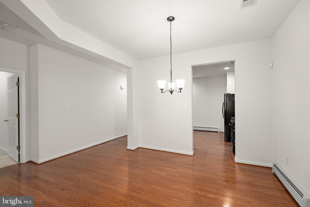 unfurnished dining area featuring hardwood / wood-style floors, a notable chandelier, and a baseboard radiator